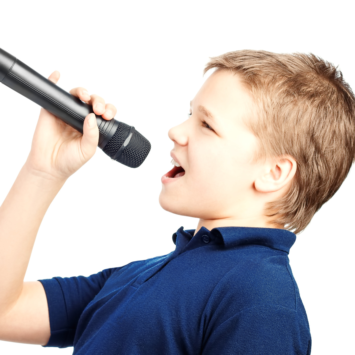 Teenage boy singing into a microphone on a white background. Very emotional.